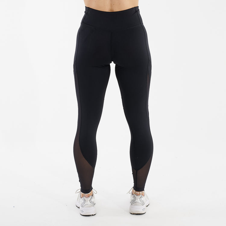 Back view of a woman wearing full length mesh panel leggings