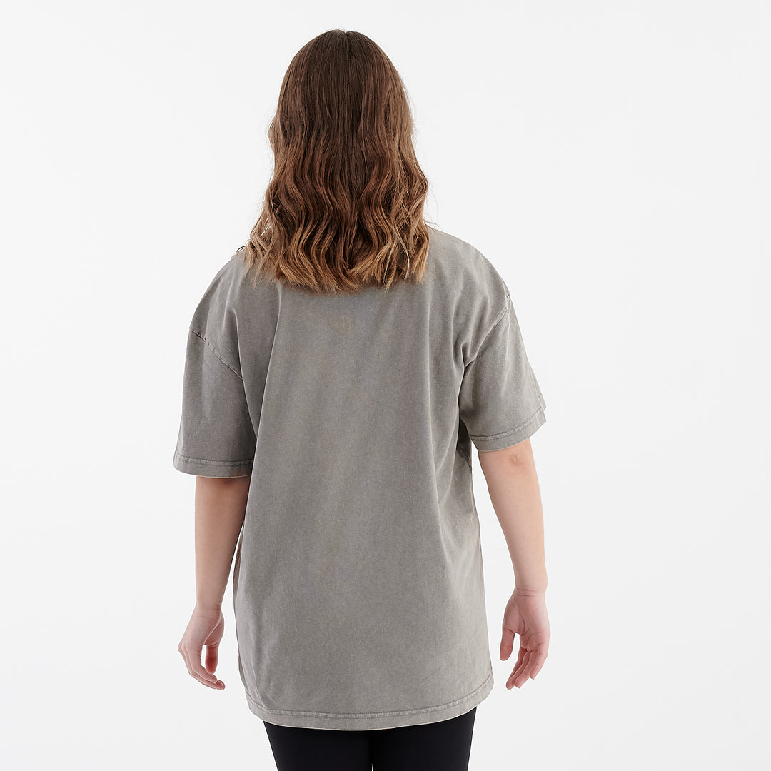 Back view of a woman wearing an oversized acid wash t-shirt asphalt