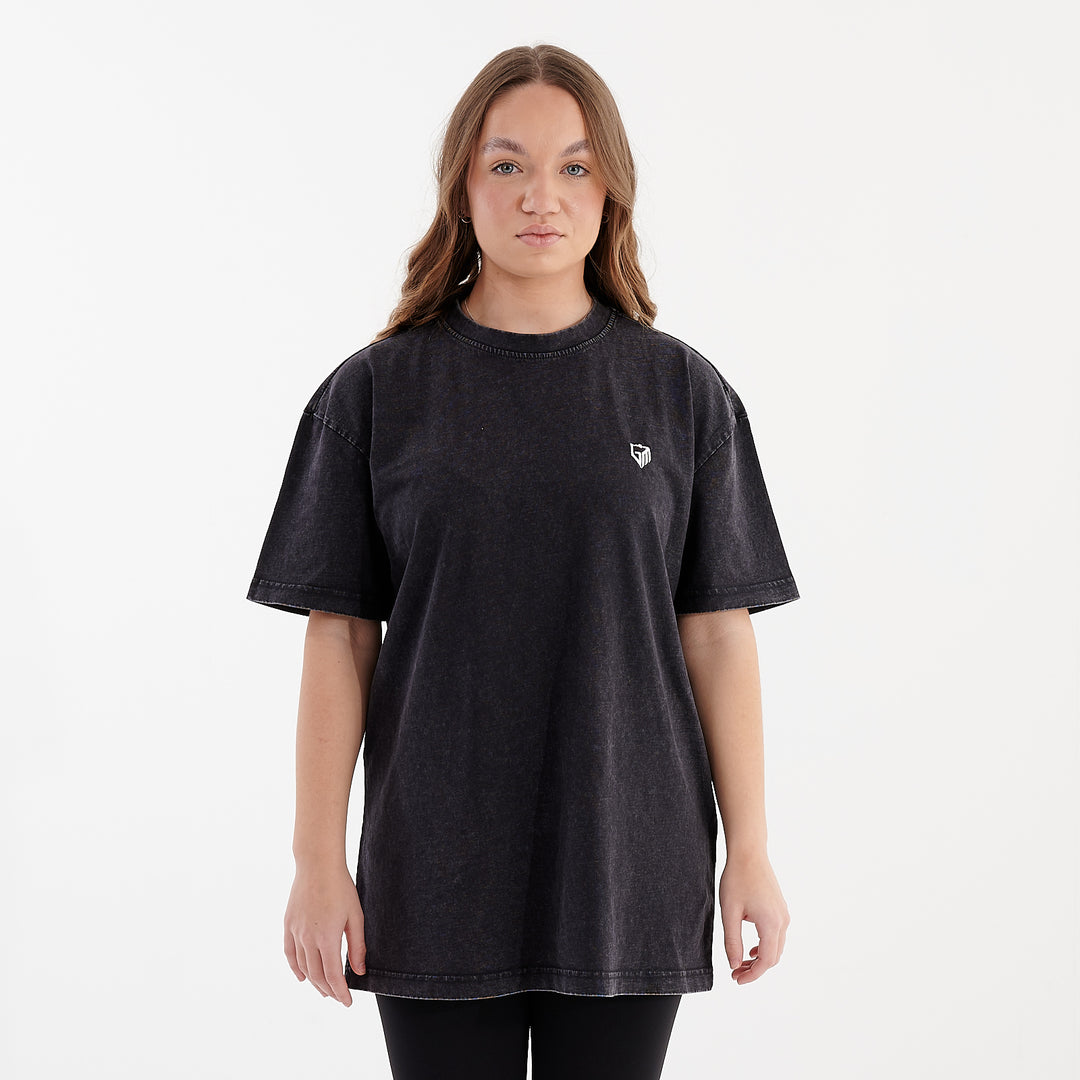 Front view of a woman wearing an oversized acid wash t-shirt black