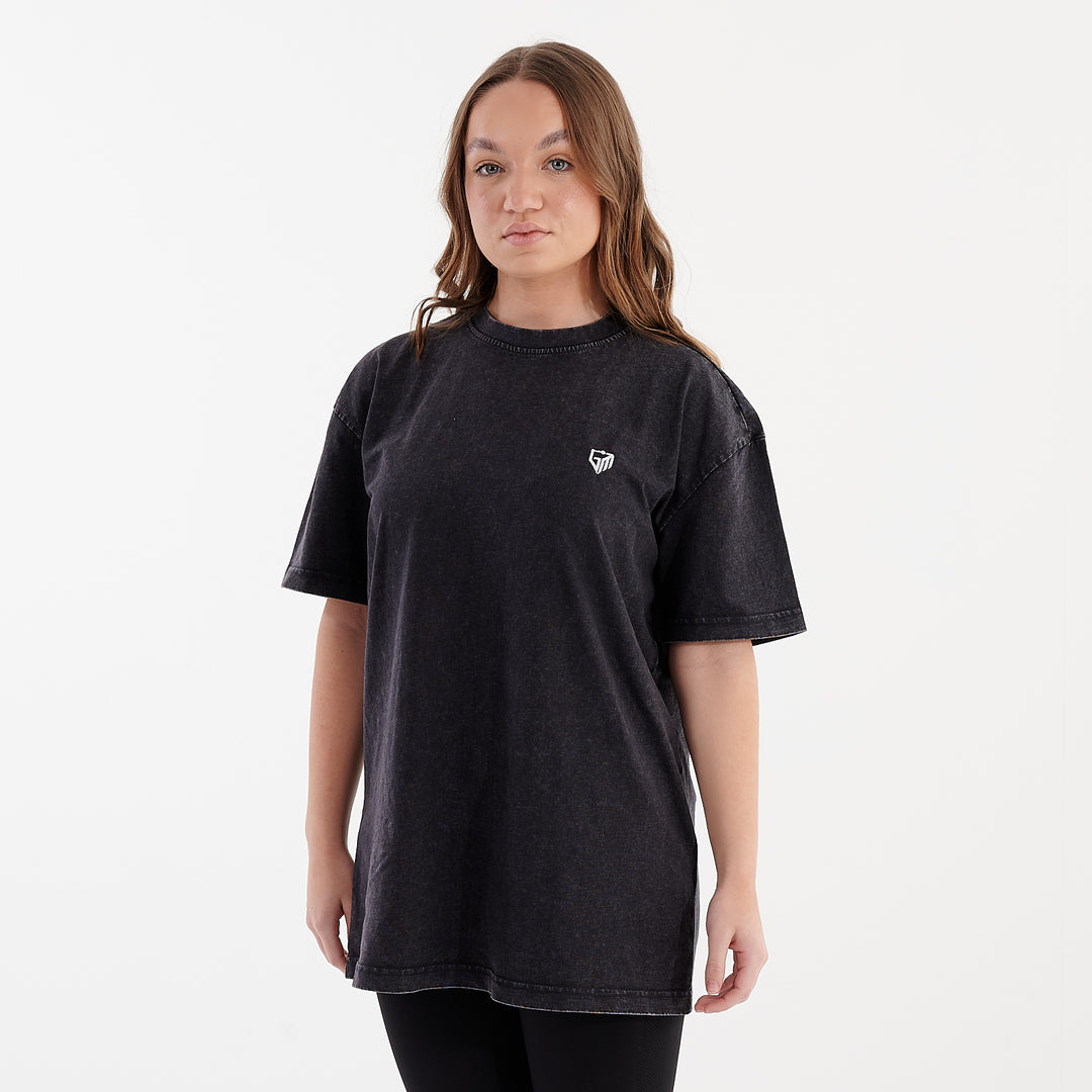 Side view of a woman wearing an oversized acid wash t-shirt black