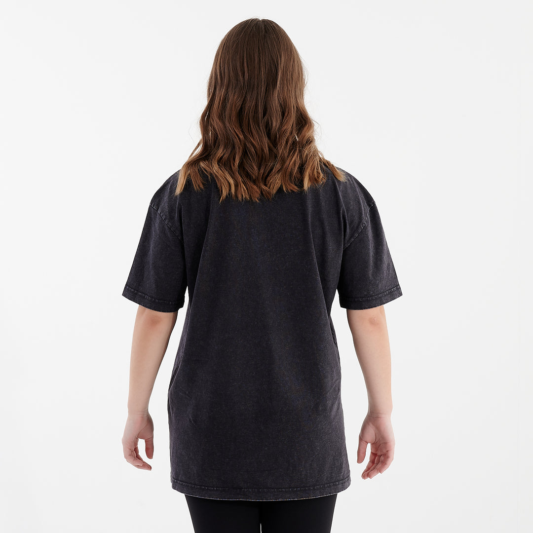 Back view of a woman wearing an oversized acid wash t-shirt black