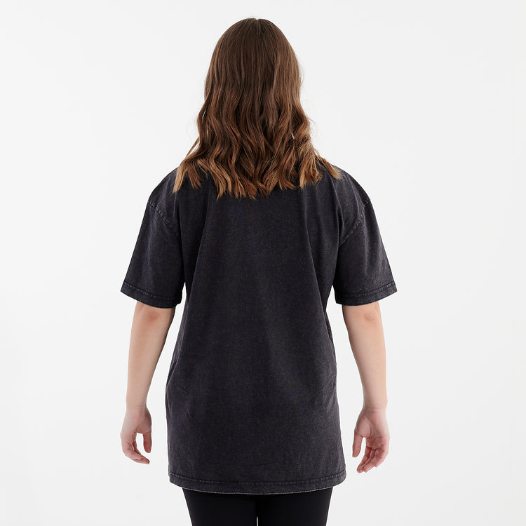 Back view of a woman wearing an oversized acid wash t-shirt black