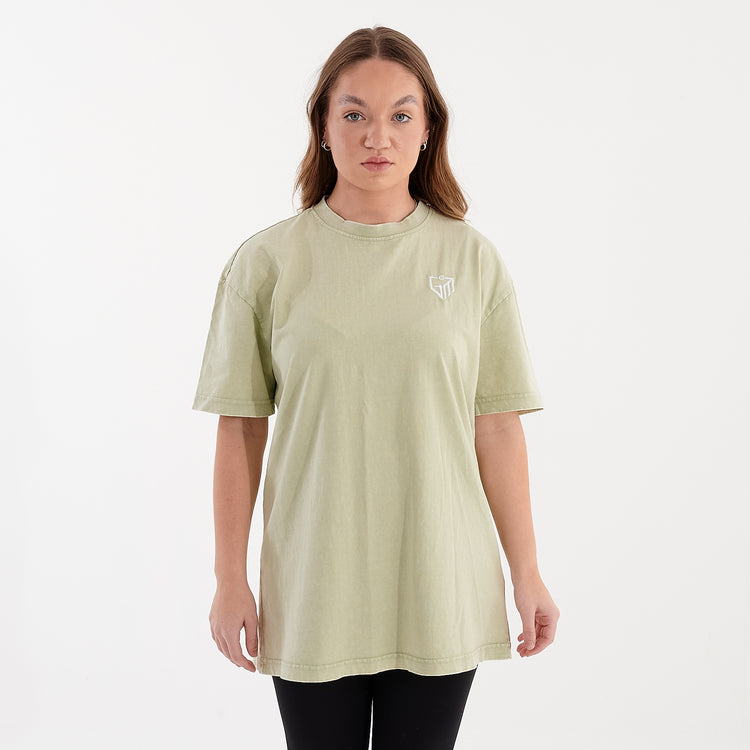 Front view of a woman wearing an oversized acid wash tee in soft salvia