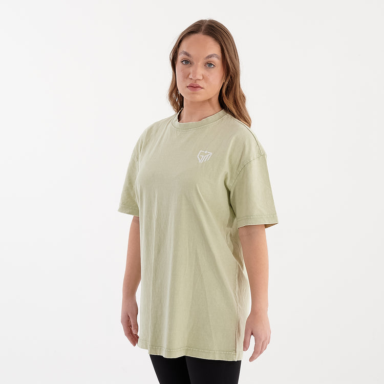Side view of a woman wearing an oversized acid wash tee in soft salvia