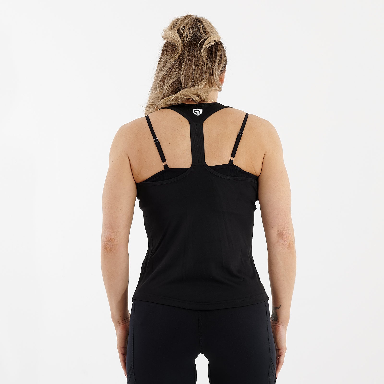 Back view of a woman wearing an active racerback vest in black