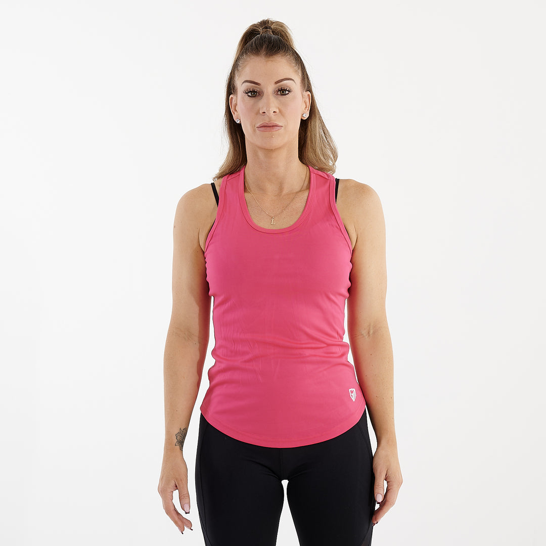 Front view of a woman wearing an active racerback vest in raspberry
