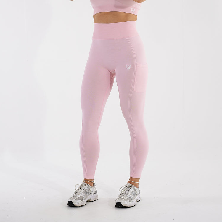 Side view of a woman wearing light pink recycled high waisted leggings