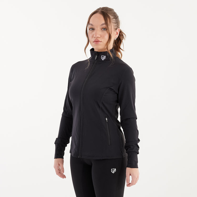 Side view of a woman wearing a black recycled fitness jacket