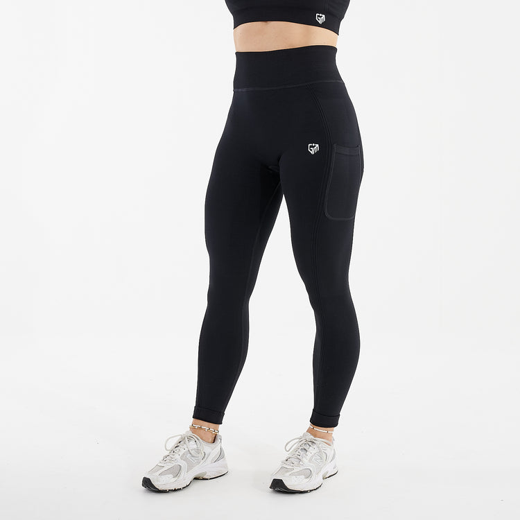 Side View of a woman wearing recycled seamless leggings black