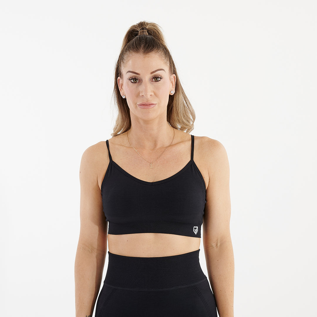 Front view of a woman wearing a black seamless flex bra