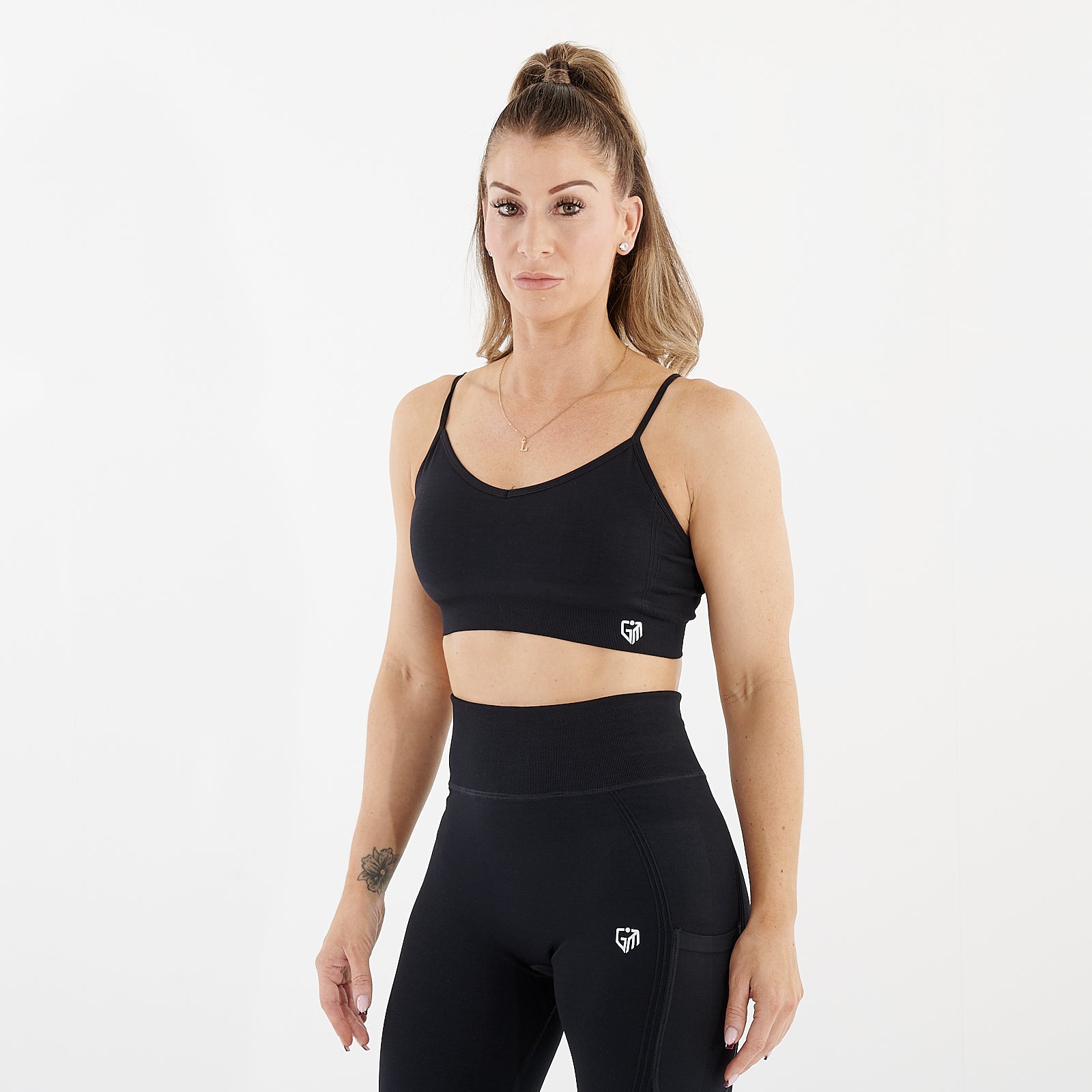 Side view of a woman wearing a black seamless flex bra