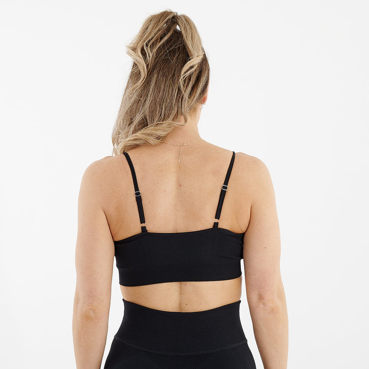 Back view of a woman wearing a black seamless flex bra