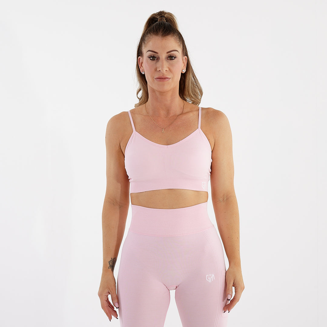 Front view of a woman wearing a light pink seamless flex bra