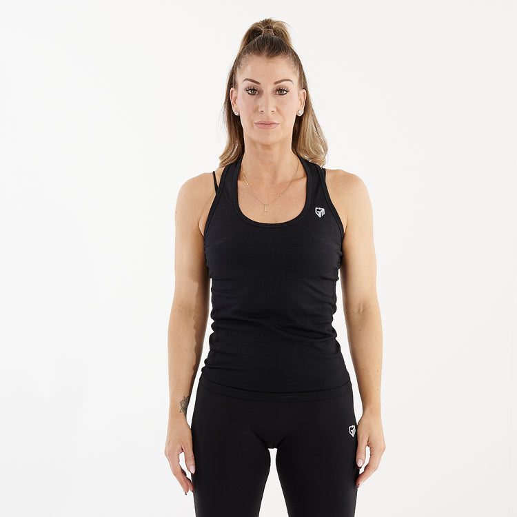 Front view of a woman wearing a black seamless racerback performance vest